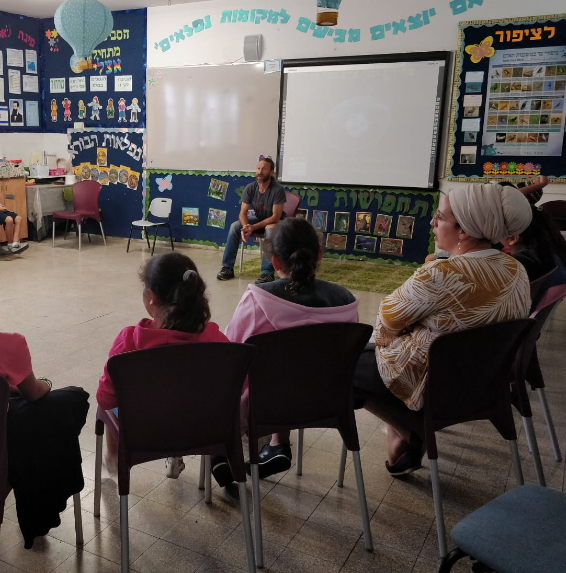Pupils and a teacher listening to a jellyfish lecture in class